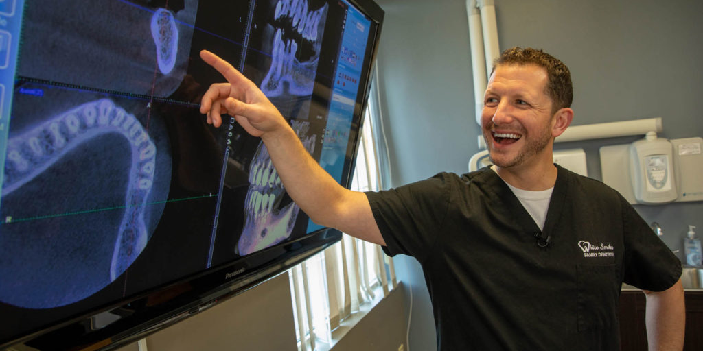Dr. white pointing at television screen